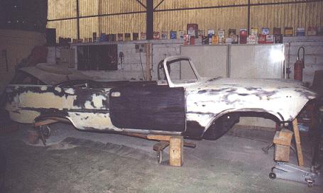 The body in phase of sheet metal work. The "frame" is a wood affair with 4 small wheels..