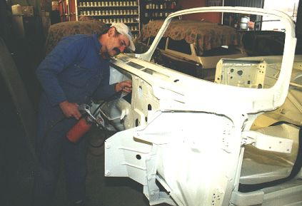 The body shop man fills the critical area (here the A/C pocket) with special filler.
